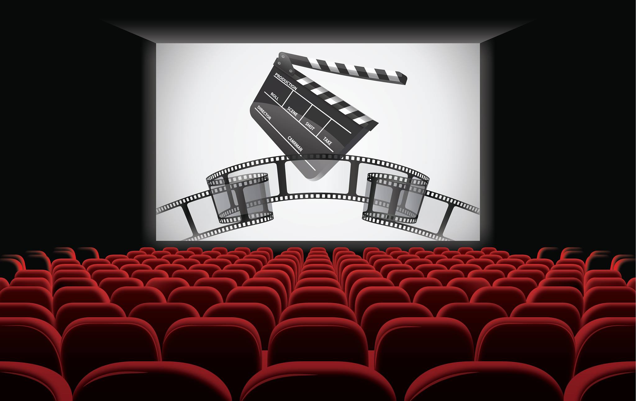 Interior de uma sala de cinema com tela grande